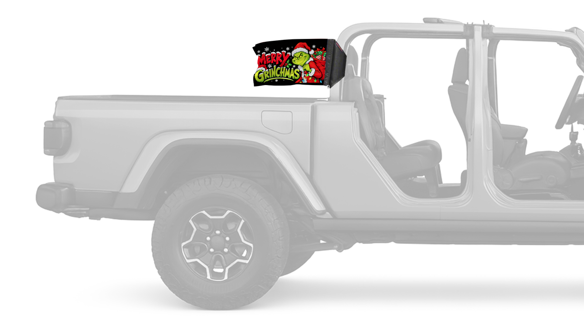 Merry Grinchmas Forever Wave flag mounted on a Jeep Gladiator roll bar sleeve